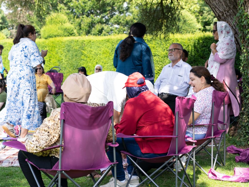 Group of people sitting in camping chairs at Kingston Maurward