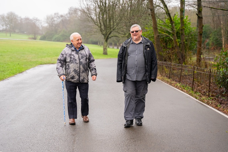Two men walking in a park